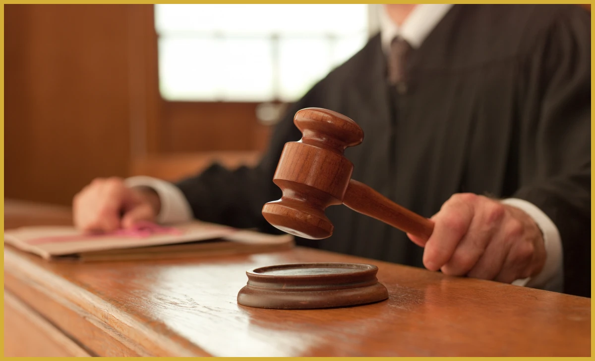 Judge holding gavel in courtroom