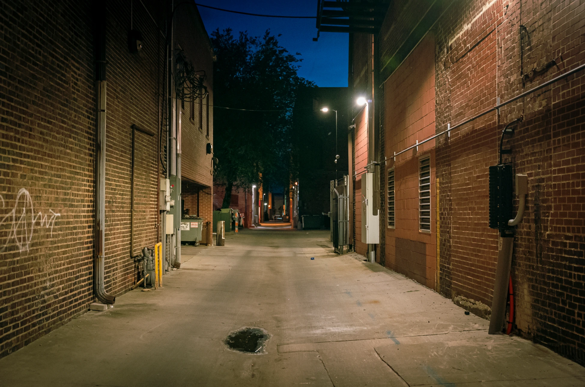 Brick walls lining a narrow alleyway