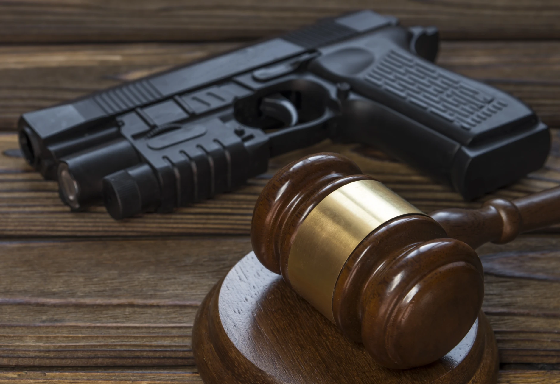 Gun and judge's gavel together